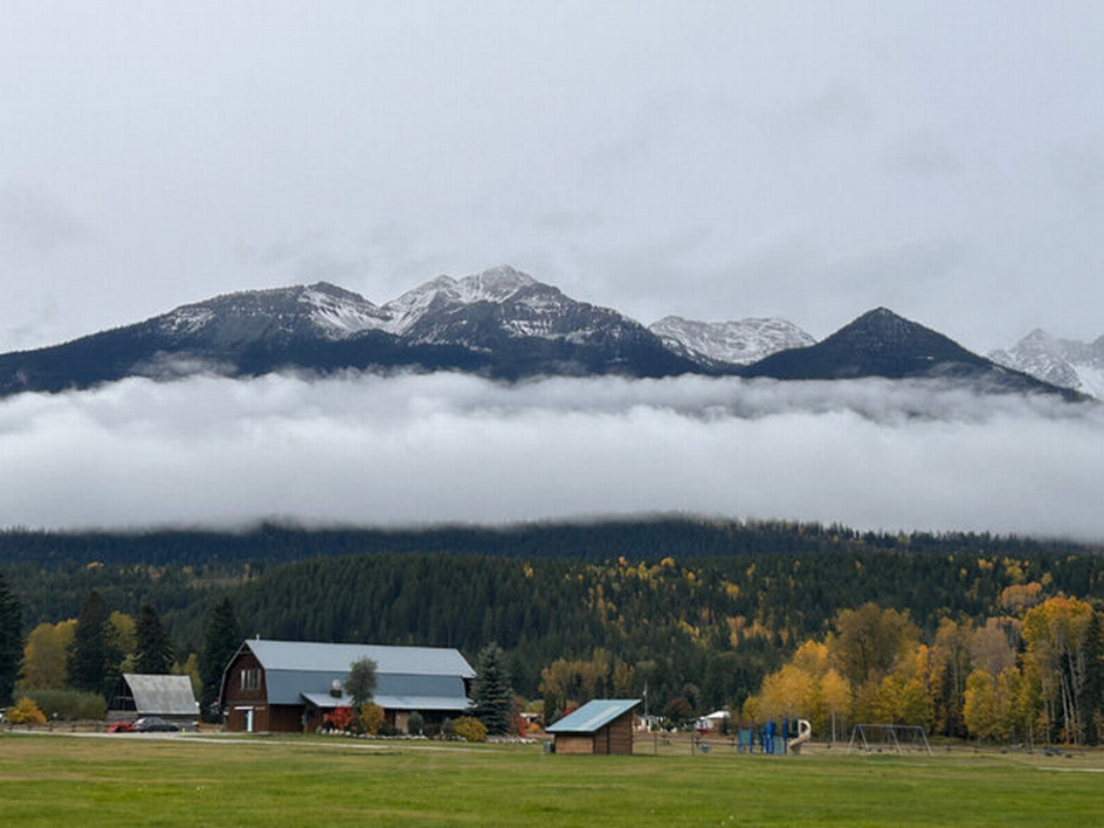 A barn and view of mountains at Golden Riverfront Campground