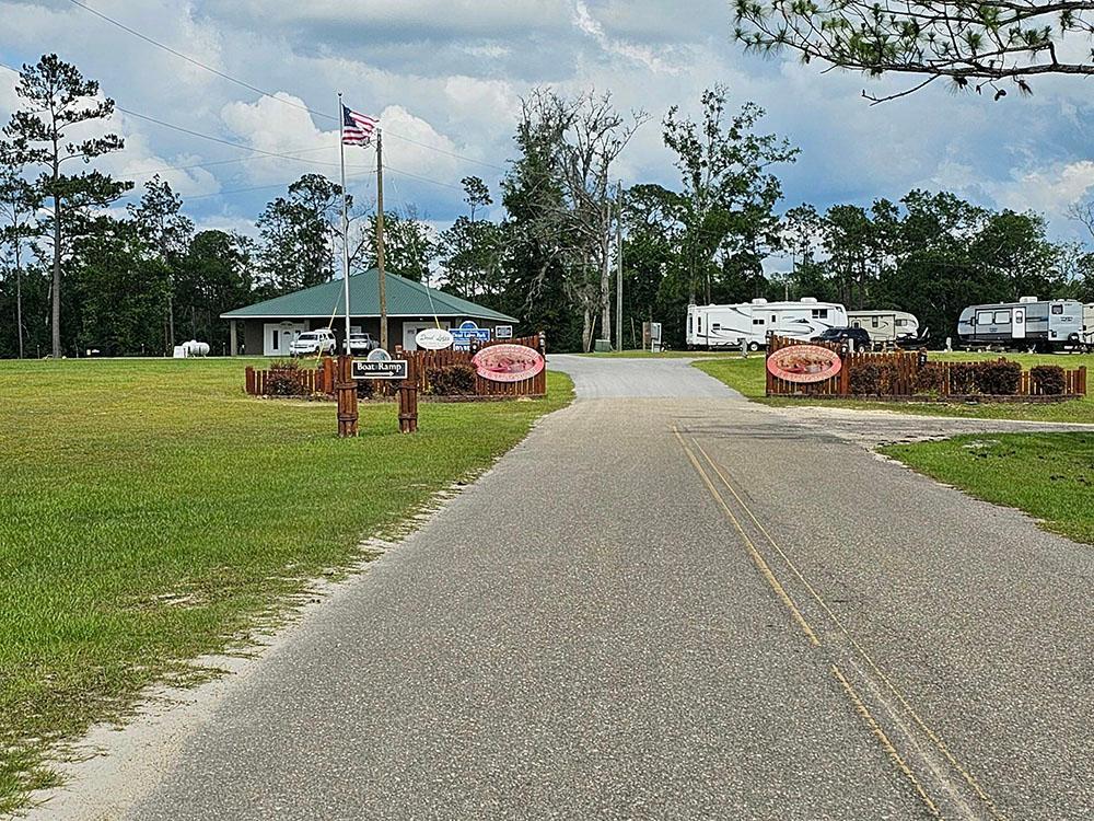 The front entrance gate with park signs on the fence at DEAD LAKES PARK RV & CAMPGROUND