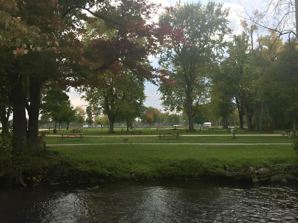 View of park with tables and creek at Veterans Memorial Park (Village Park)