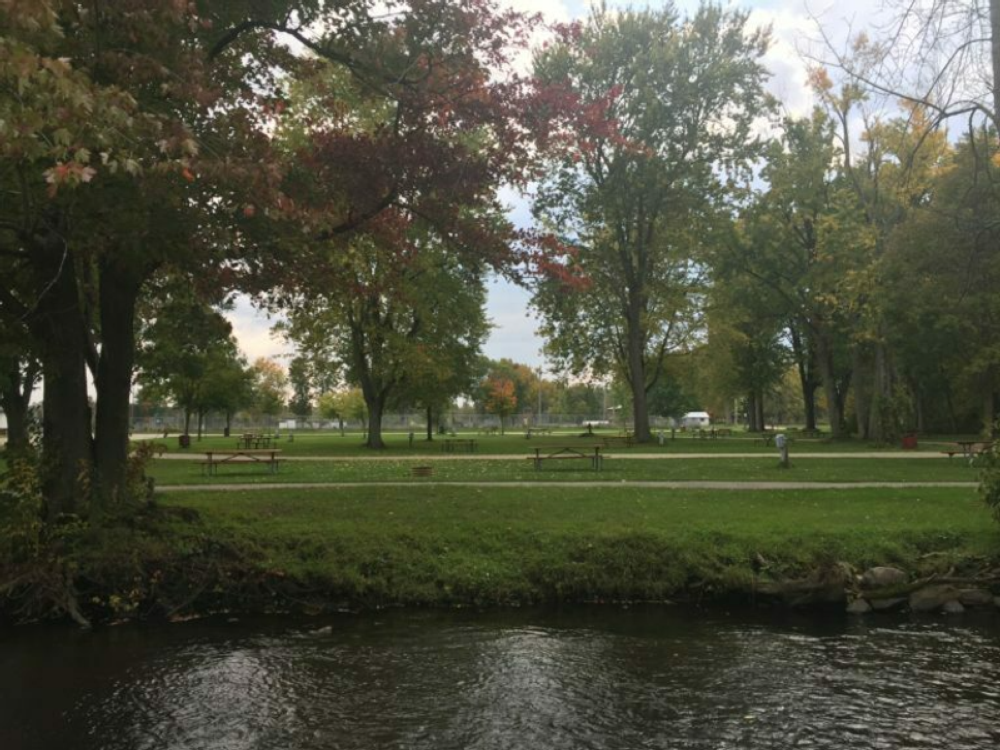 View of park with tables and creek at Veterans Memorial Park (Village Park)