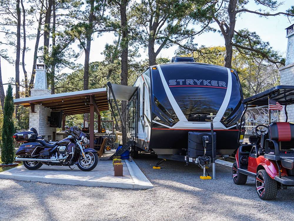 Travel trailer, motorcycle and golf cart at a site at Myrtle Beach Campgrounds