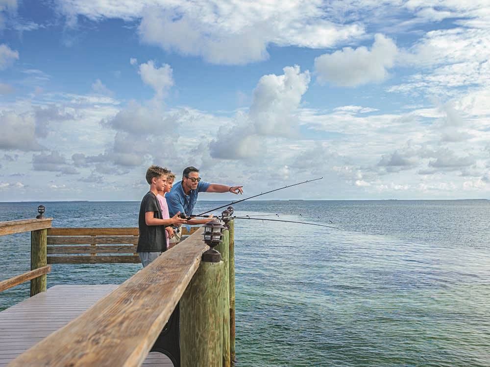 A dad teaching his sons how to fish nearby at BIG PINE KEY & FLORIDA LOWER KEYS