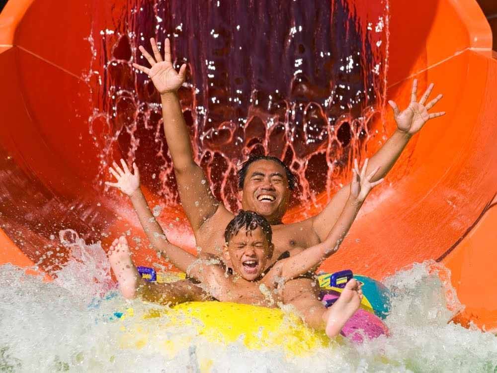 Father and son enjoying a water slide at PEI PROVINCIAL PARKS