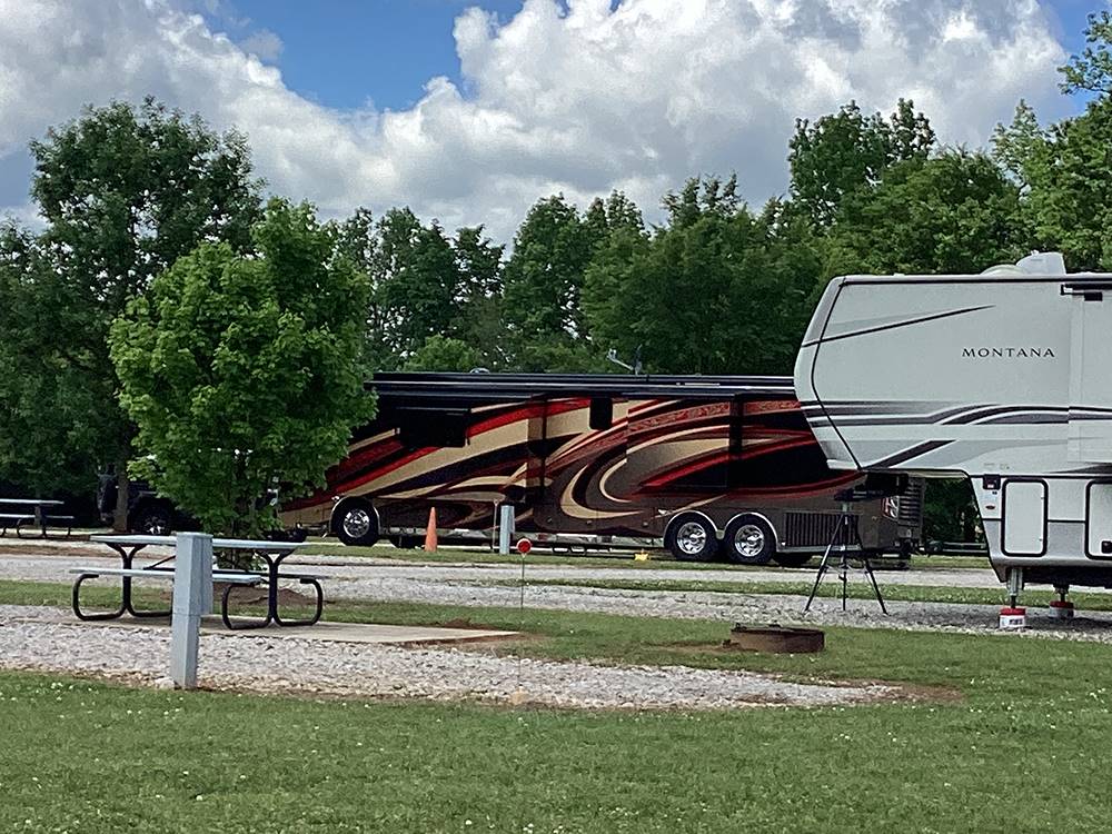 Class A and fifth wheel parked at gravel sites at Camping World-Campground of Oxford