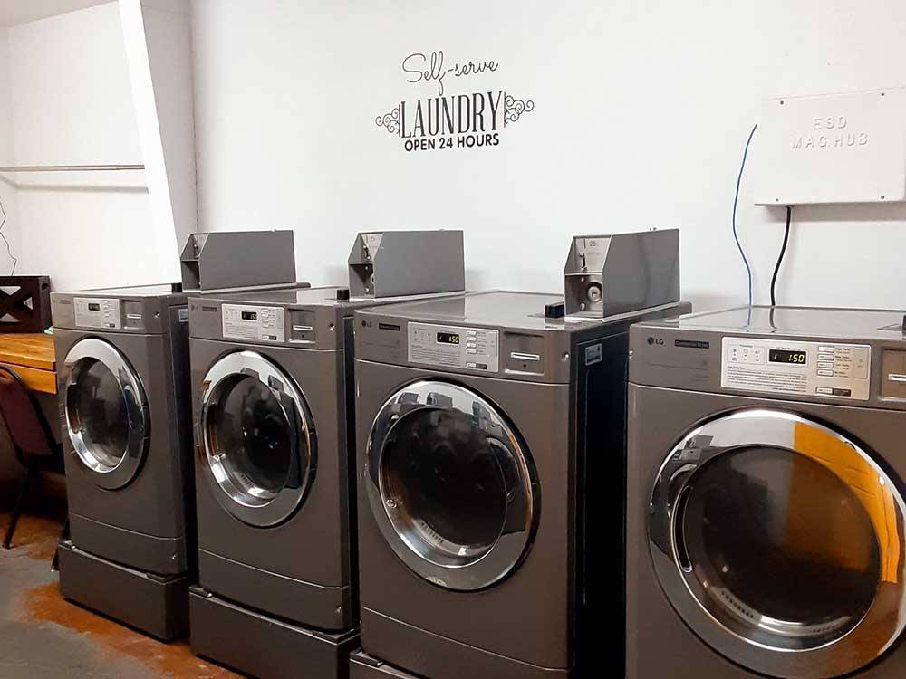 A row of coin-operated clothes dryers at TULSA RV RANCH