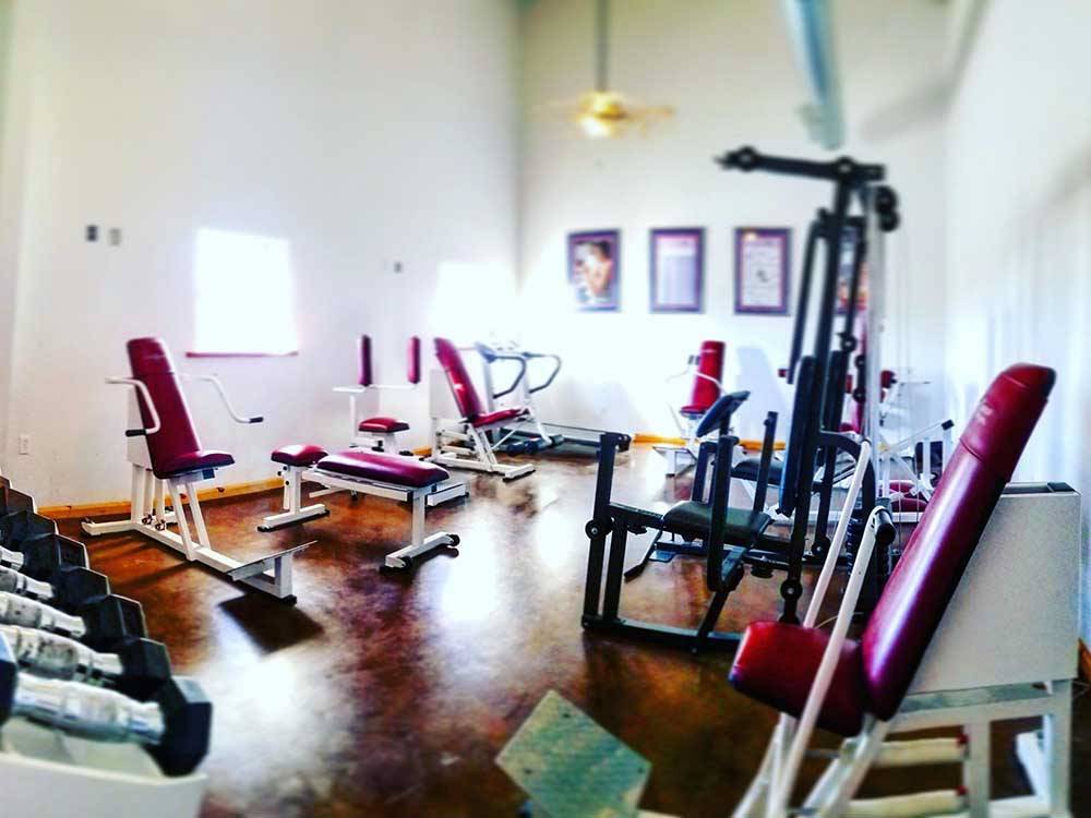 Exercise room with several weight machines at TULSA RV RANCH