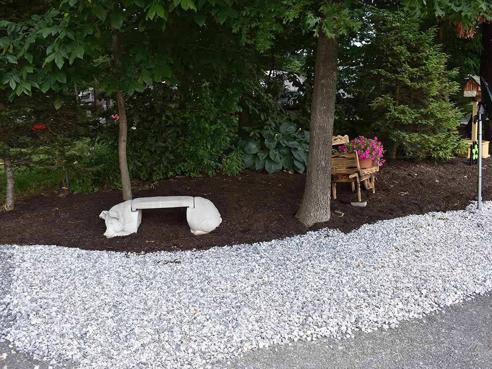 A concrete pig bench in a planter at OMA'S FAMILY CAMPGROUND