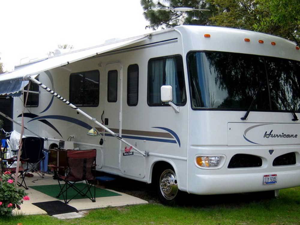 A motorhome parked in a site at WHISPERING PINES