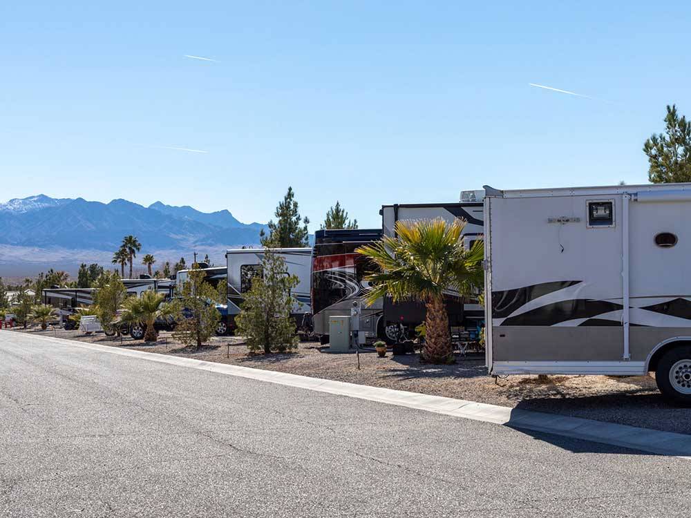 RV sites line a paved road with mountains in background at SUN RESORTS RV PARK