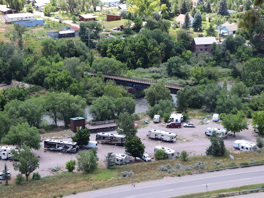 Aerial view of RV park between a river and a highway at GATEWAY RV PARK