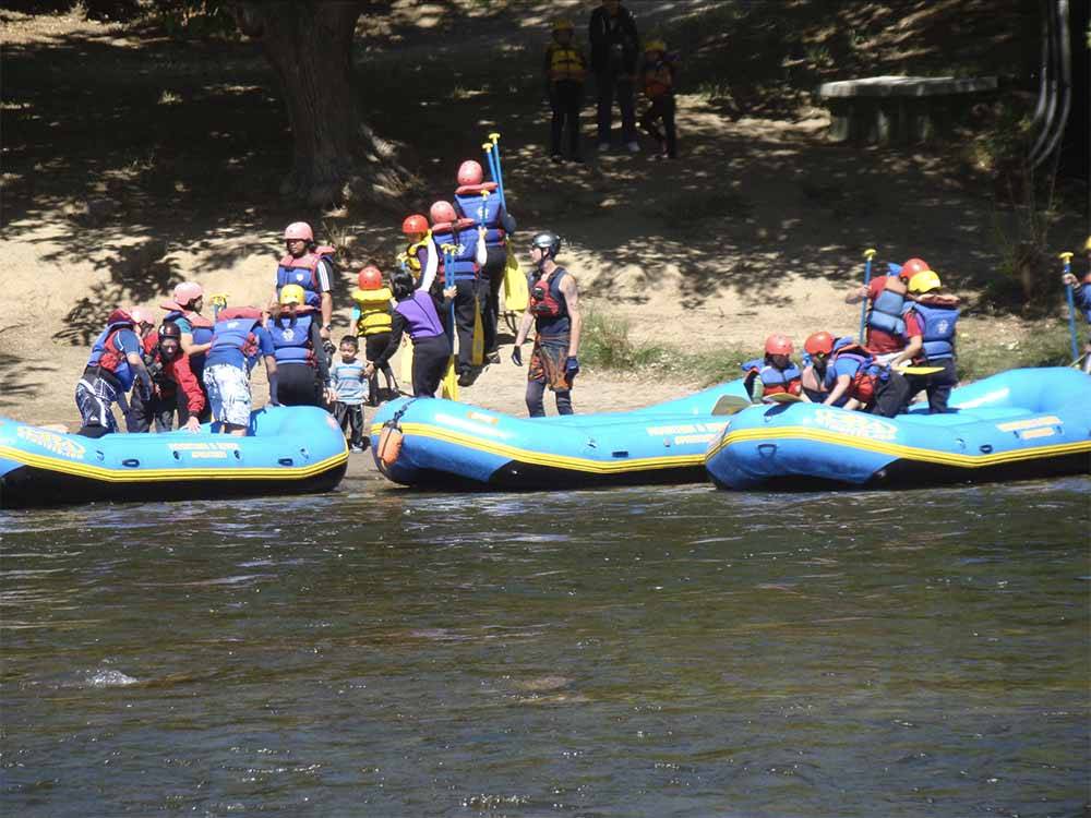 People standing next to inflatable rafts at FRANDY PARK CAMPGROUND