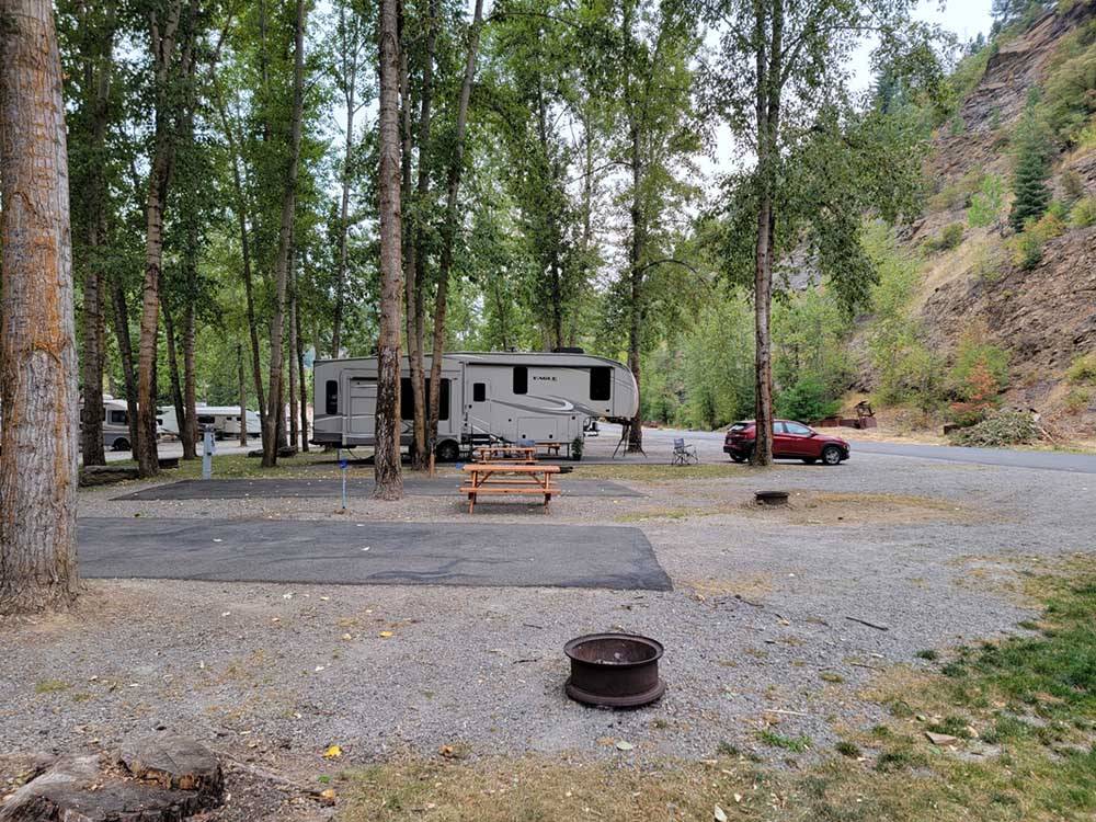 A fifth wheel parked in a paved RV site at CRYSTAL GOLD MINE & RV PARK