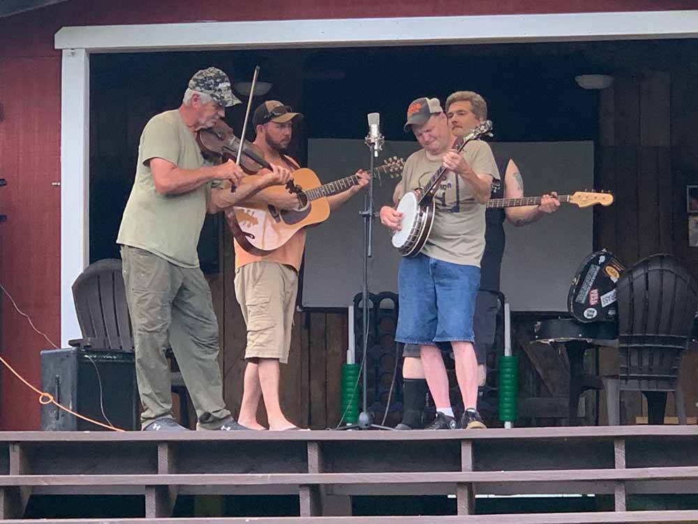 A band playing on the stage at TRIPLE CREEK CAMPGROUND