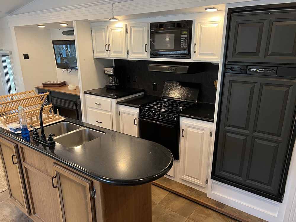 The kitchen area in a fifth wheel trailer at TRIPLE CREEK CAMPGROUND