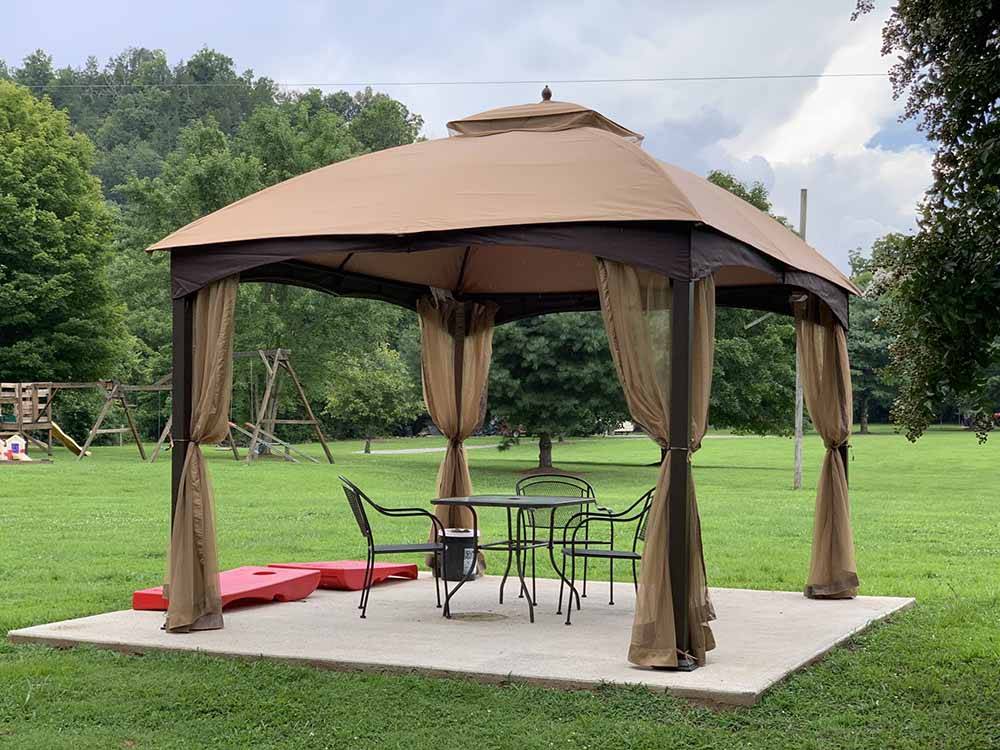 A gazebo with seating at TRIPLE CREEK CAMPGROUND