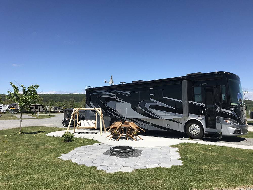 RV with swing and firepit at Bas-St-Laurent Campground