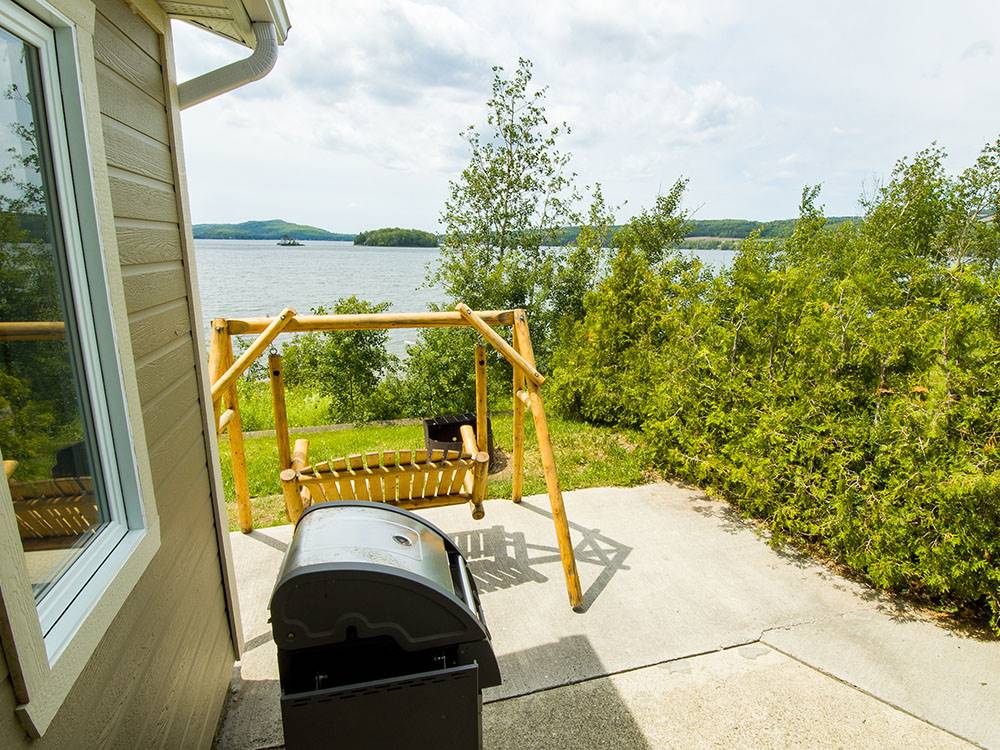 BBQ next to swing at Bas-St-Laurent Campground