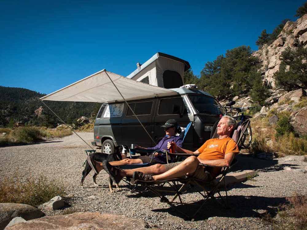 People sitting outside of their VW van