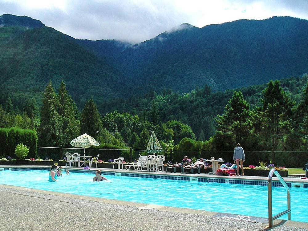 Swimming pool with outdoor seating at THOUSAND TRAILS CULTUS LAKE