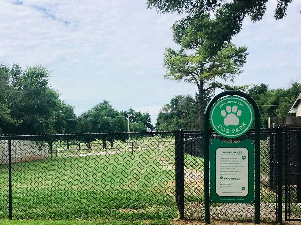 Fenced, grassy dog park at PECAN GROVE RV RESORT