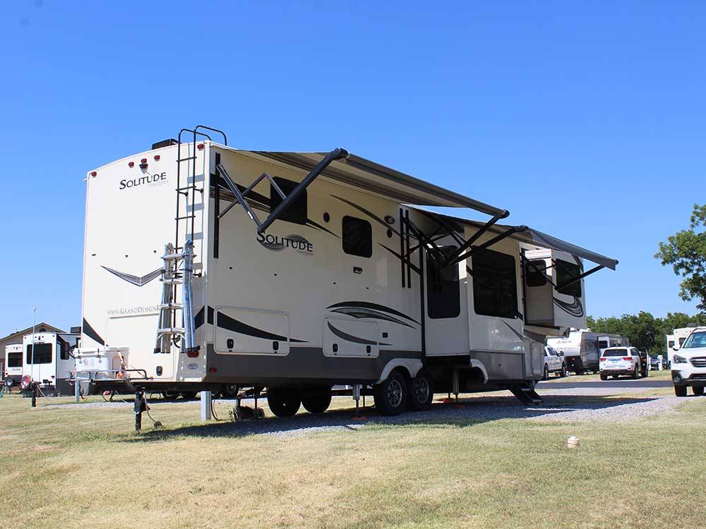A trailer in an RV site at PECAN GROVE RV RESORT