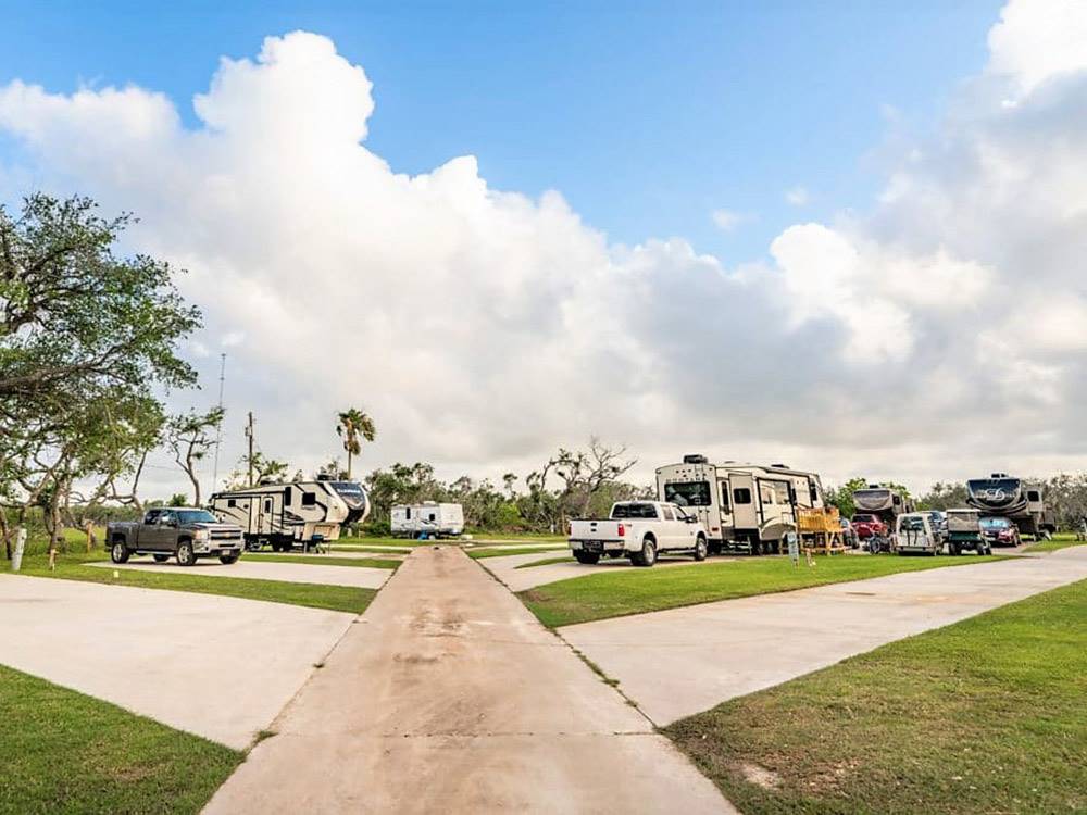 The road between the gravel RV sites at ROCKPORT RV RESORT BY RJOURNEY
