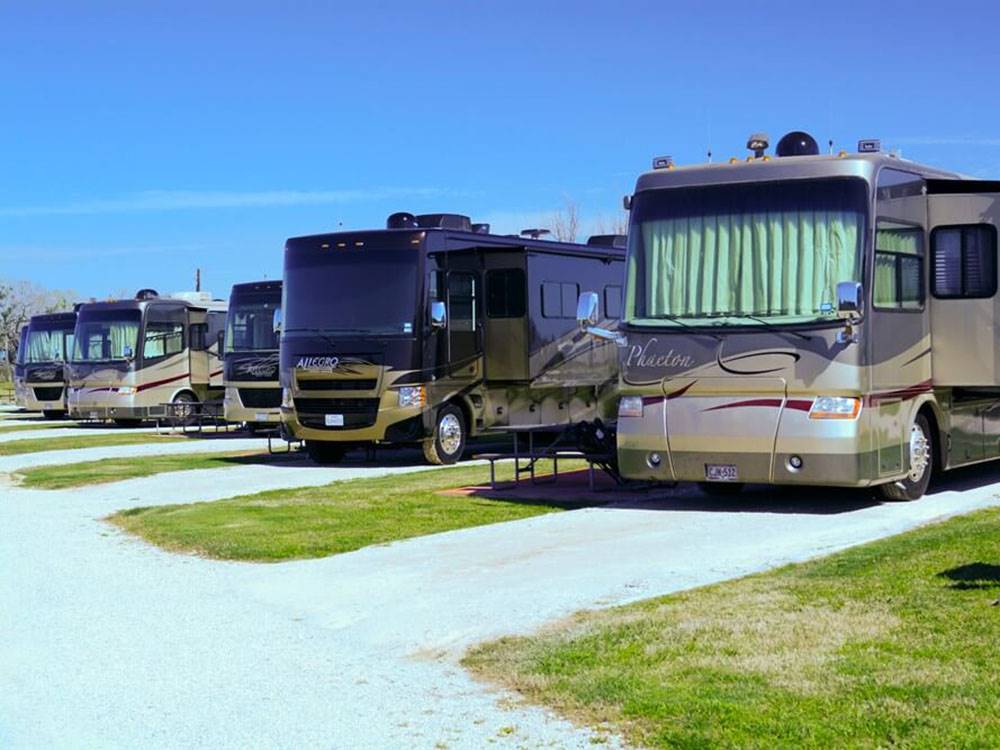 A row of motorhomes parked at VICTORIA COLETO LAKE RV RESORT