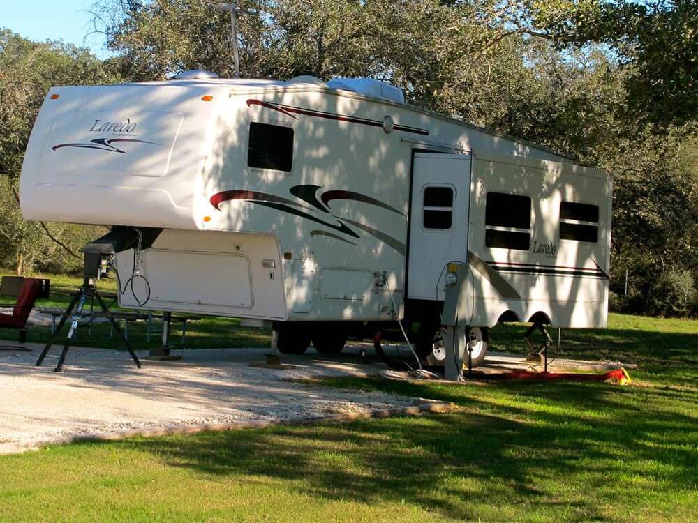 Fifth wheel trailer in a paved site at VICTORIA COLETO LAKE RV RESORT