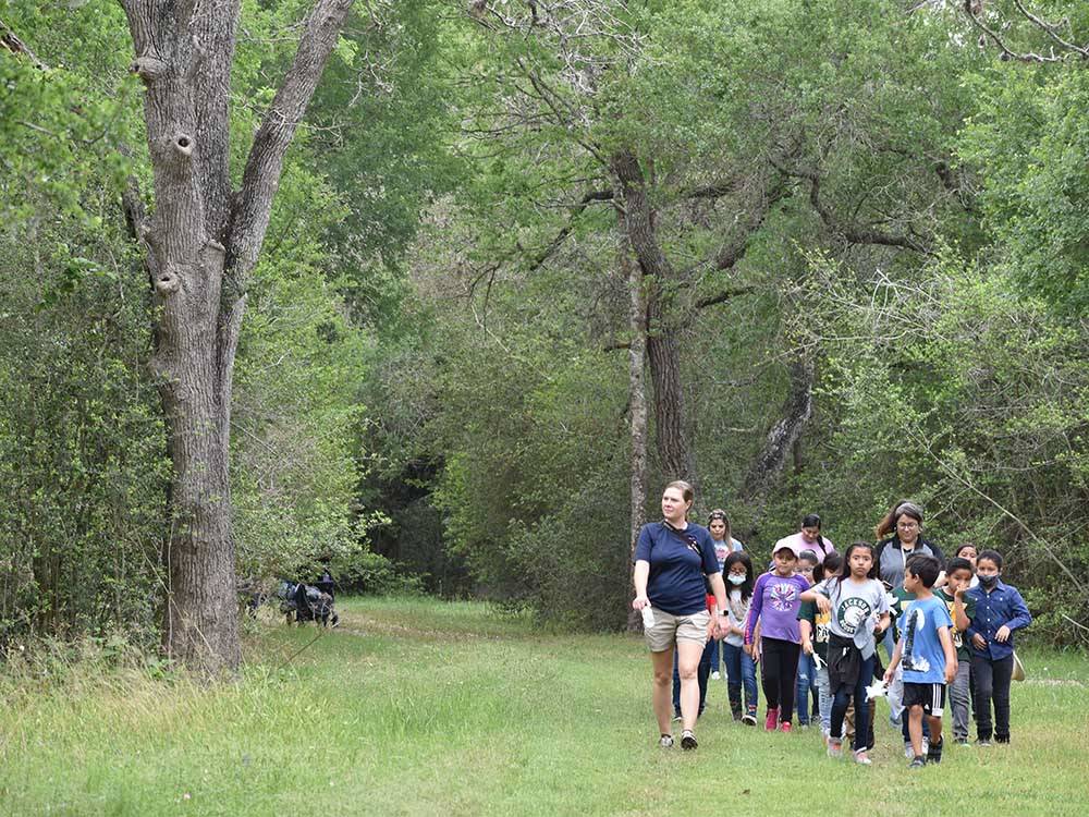 A group of kids and staff taking a hike at BRACKENRIDGE RECREATION COMPLEX-TEXANA PARK & CAMPGROUND