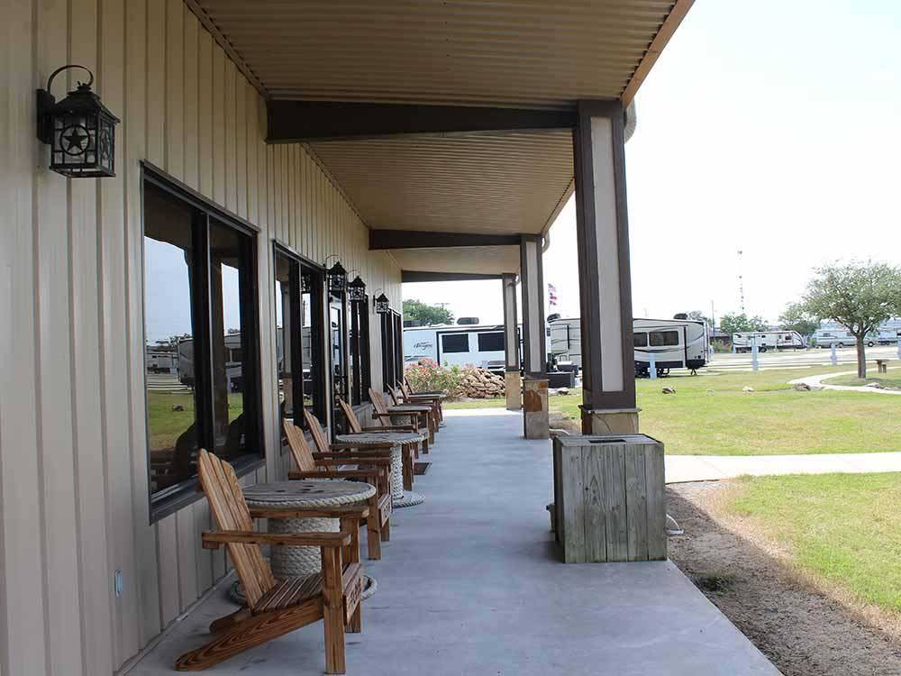 Wooden chairs in front of the office at TEXAS LAKESIDE RV RESORT