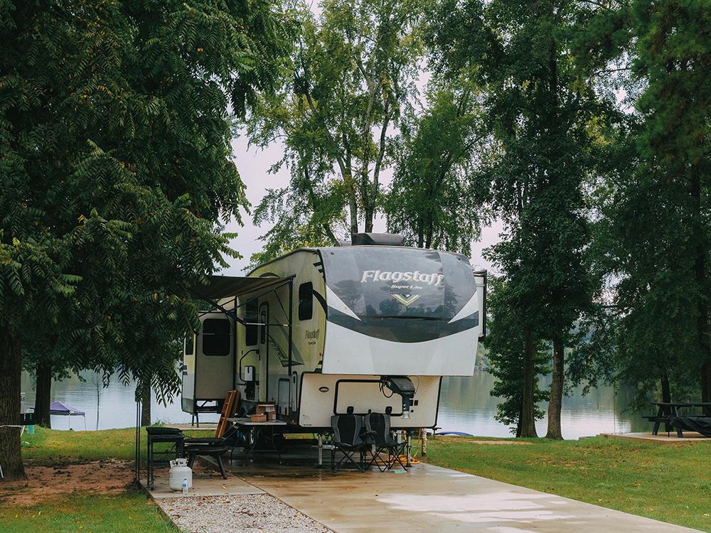 A large RV at site by the lake