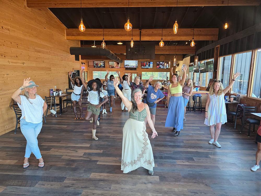 A room of ladies line dancing