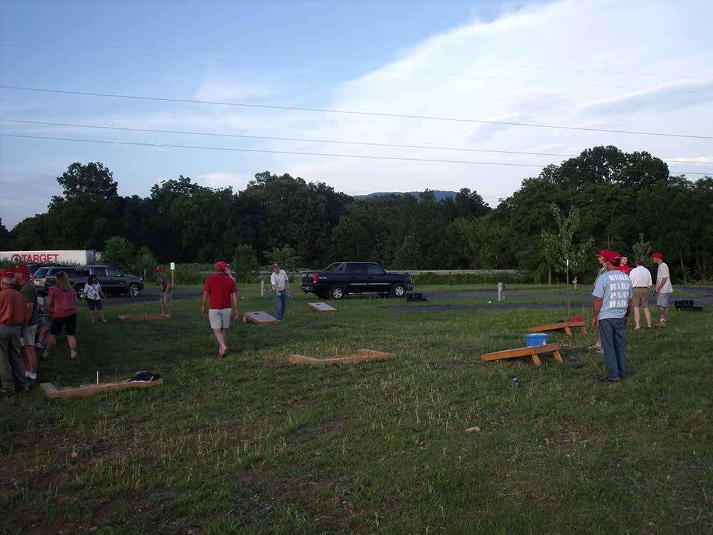 A group of people playing cornhole at SHENANDOAH VALLEY CAMPGROUNDS