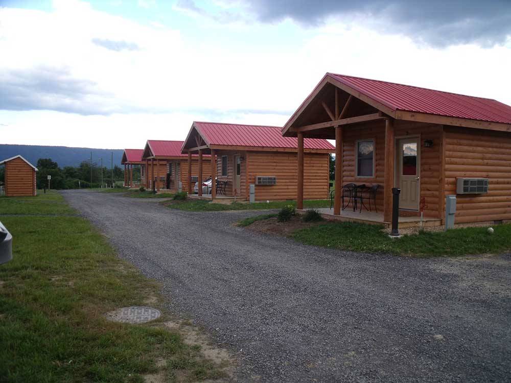 A row of rental log cabins at SHENANDOAH VALLEY CAMPGROUNDS