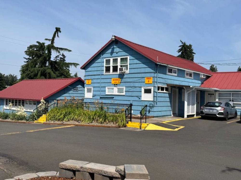 Exterior of the blue office with red roof