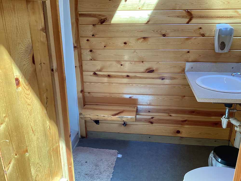 A wooden walled bathroom at SHELBY RV PARK AND RESORT