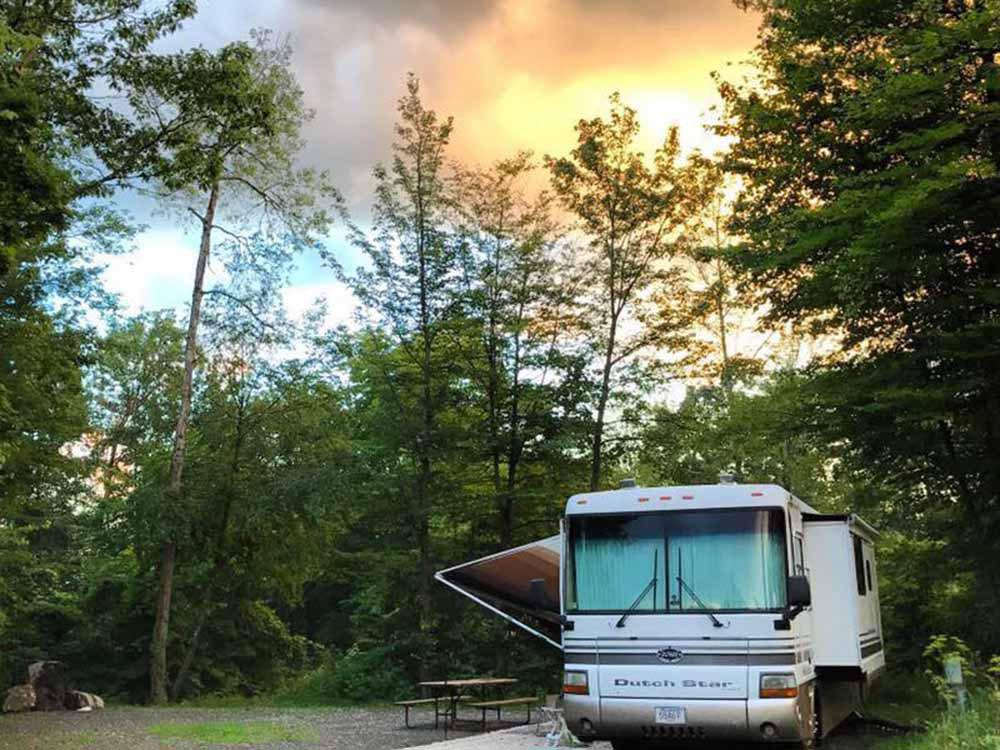 A motorhome backed in at a RV site at MOOSE HILLOCK CAMPING RESORT NY