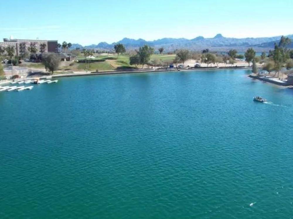 Waterfront with a boat at Route 66 Golden Shores RV Park