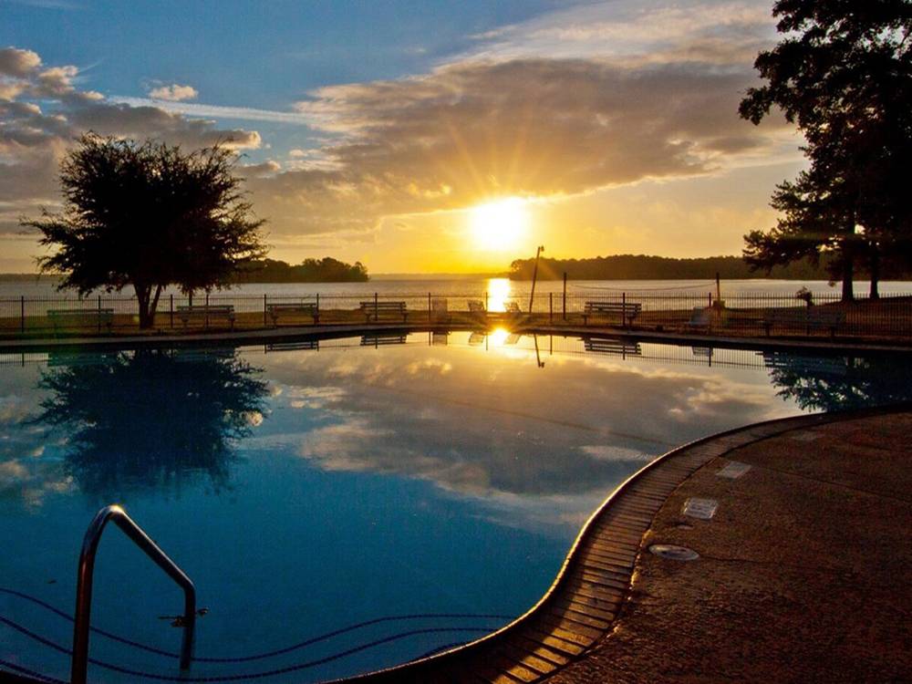 The sun reflects on the lake and pool