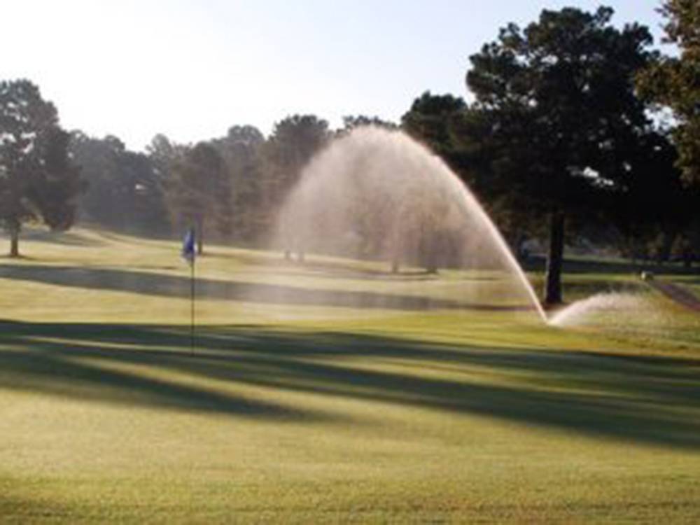 Golf course with water sprinkler