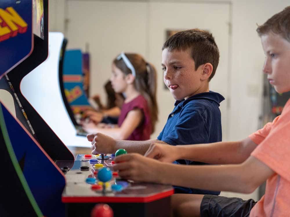 Kids playing the arcade games at PALMETTO SHORES RV RESORT