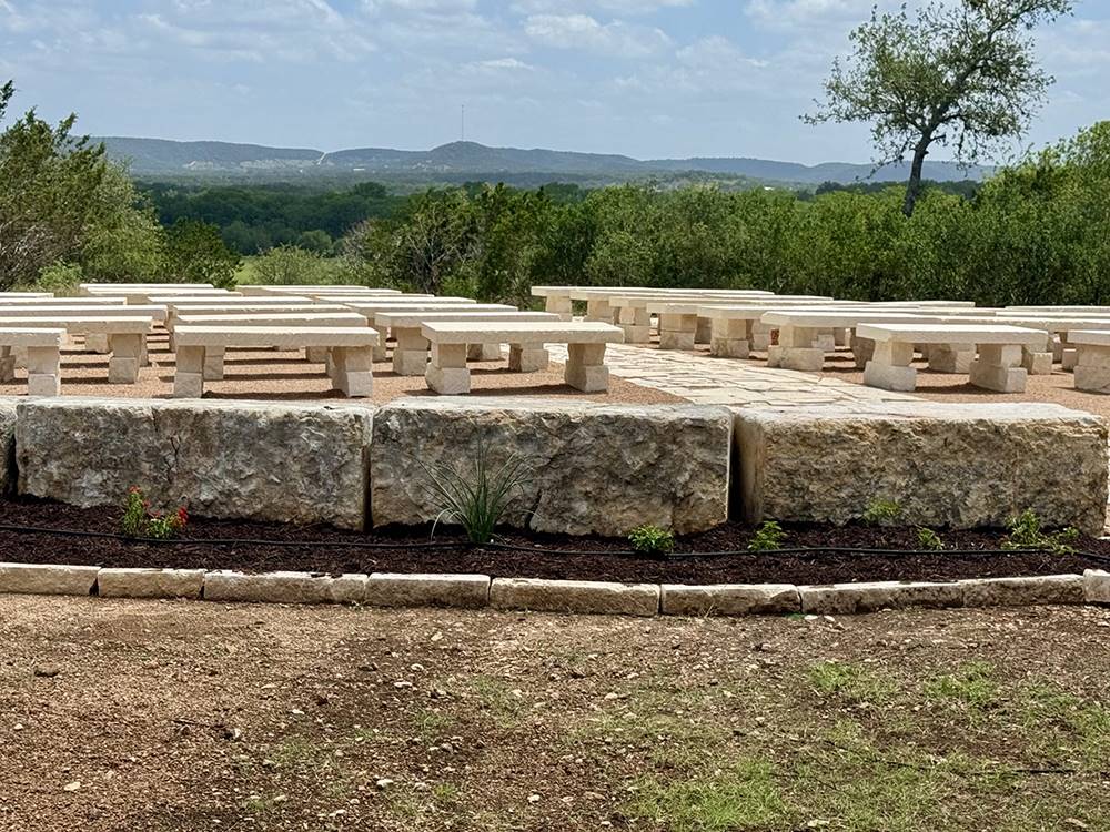 Outdoor stone bench seating at the wedding venue