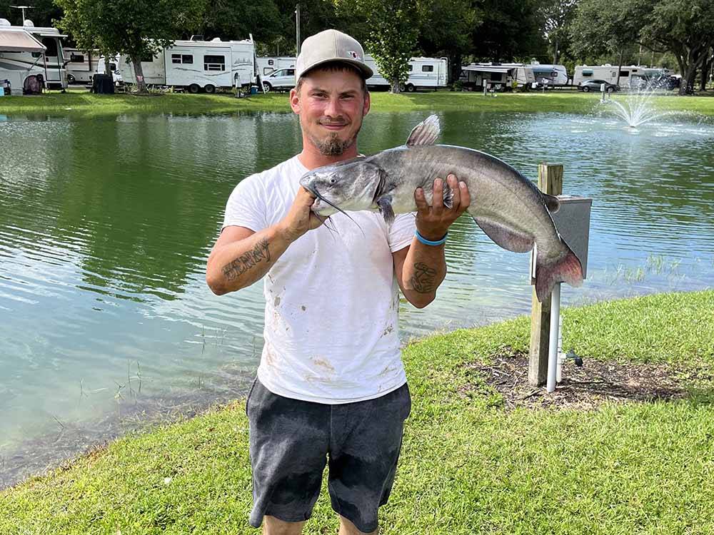 Angler holds up fish he just caught at GAINESVILLE RV PARK