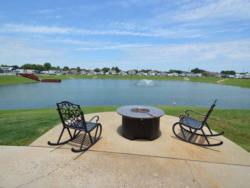 A fire pit overlooking the lake at KATY LAKE RV RESORT