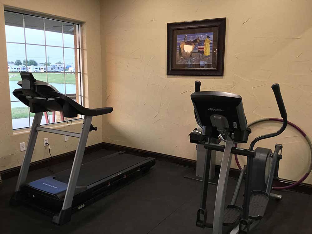 Exercise room with elliptical machine and treadmill at KATY LAKE RV RESORT