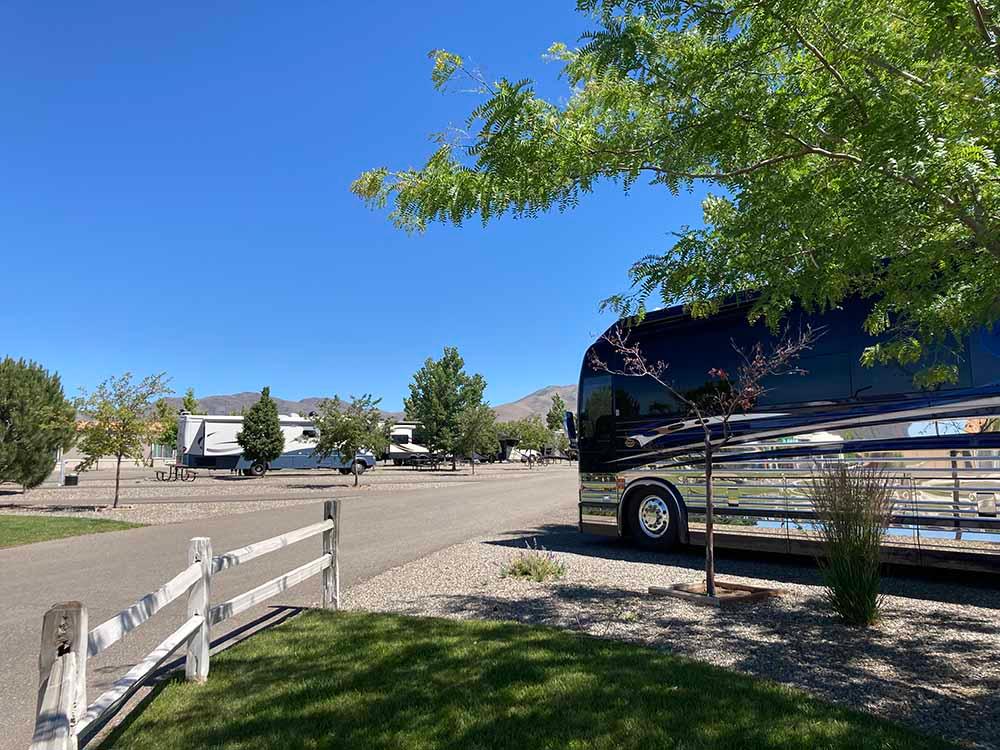 A motorhome in a paved RV site at NEW FRONTIER RV PARK
