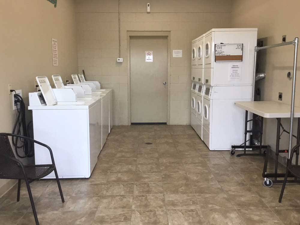 Laundry room with washer and dryers at BY THE LAKE RV PARK