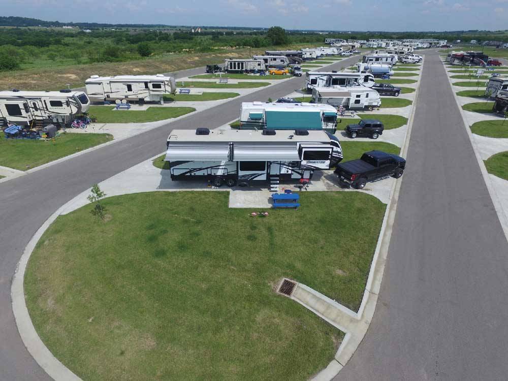 Aerial view of RVs parked in pull-thru sites at BY THE LAKE RV PARK