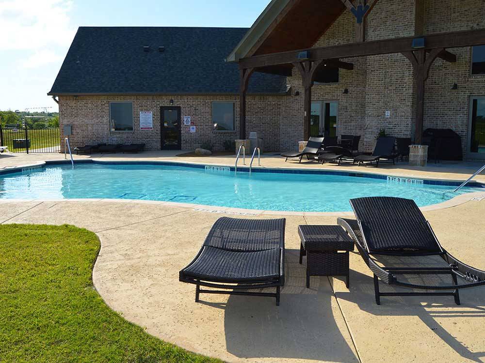 Swimming pool with outdoor seating at BY THE LAKE RV PARK