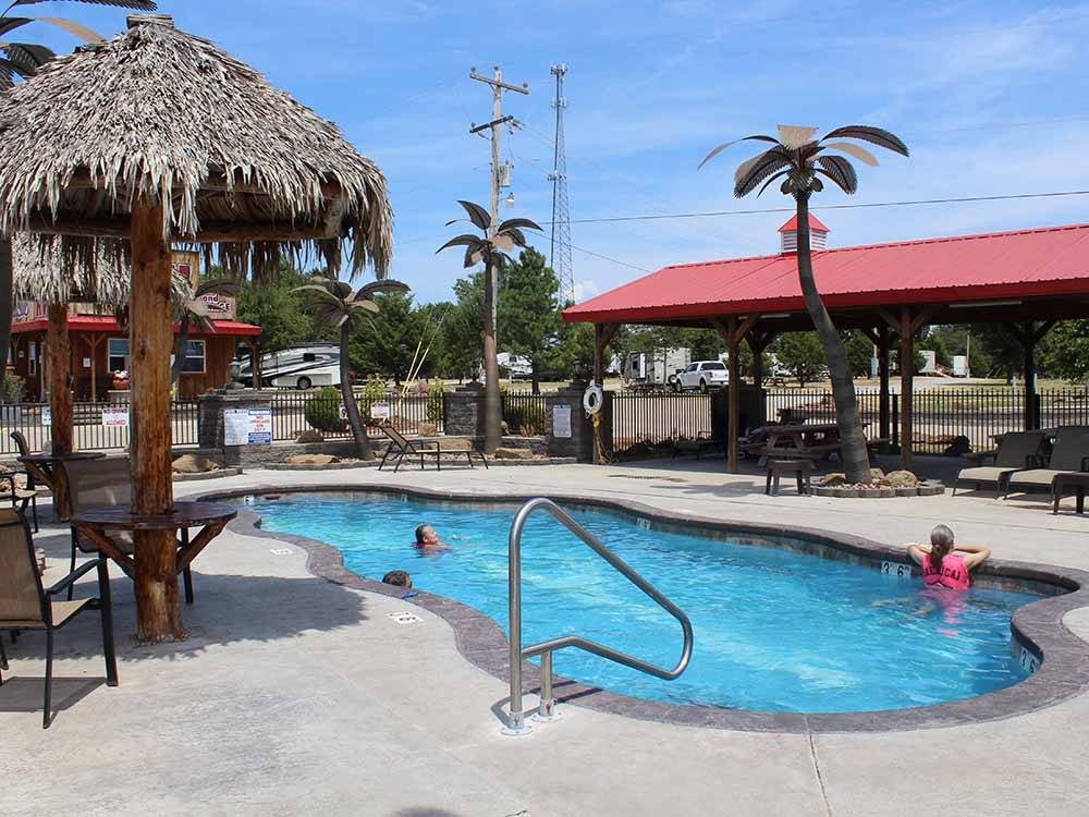 Seating around the swimming pool at LITTLE TURTLE RV & STORAGE